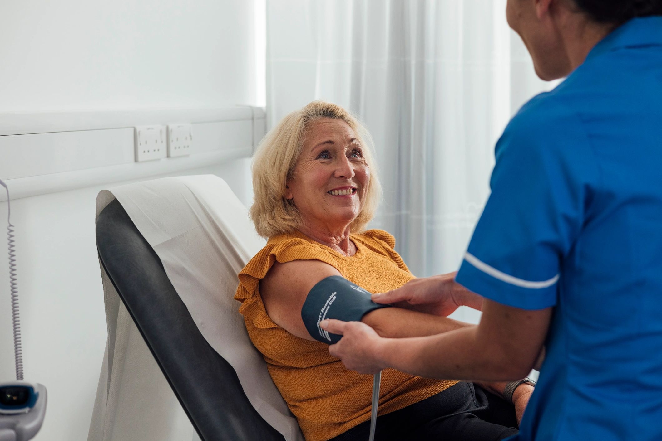 Clinician performing a routine health check in a modern clinic